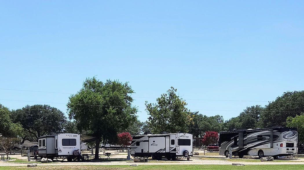 Bending Oaks Ranch RV Park - Adult-only RV resort with RVs parked under large oak trees in Fredericksburg, Texas